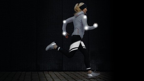 Woman athlete running illustrating reflective embellishments